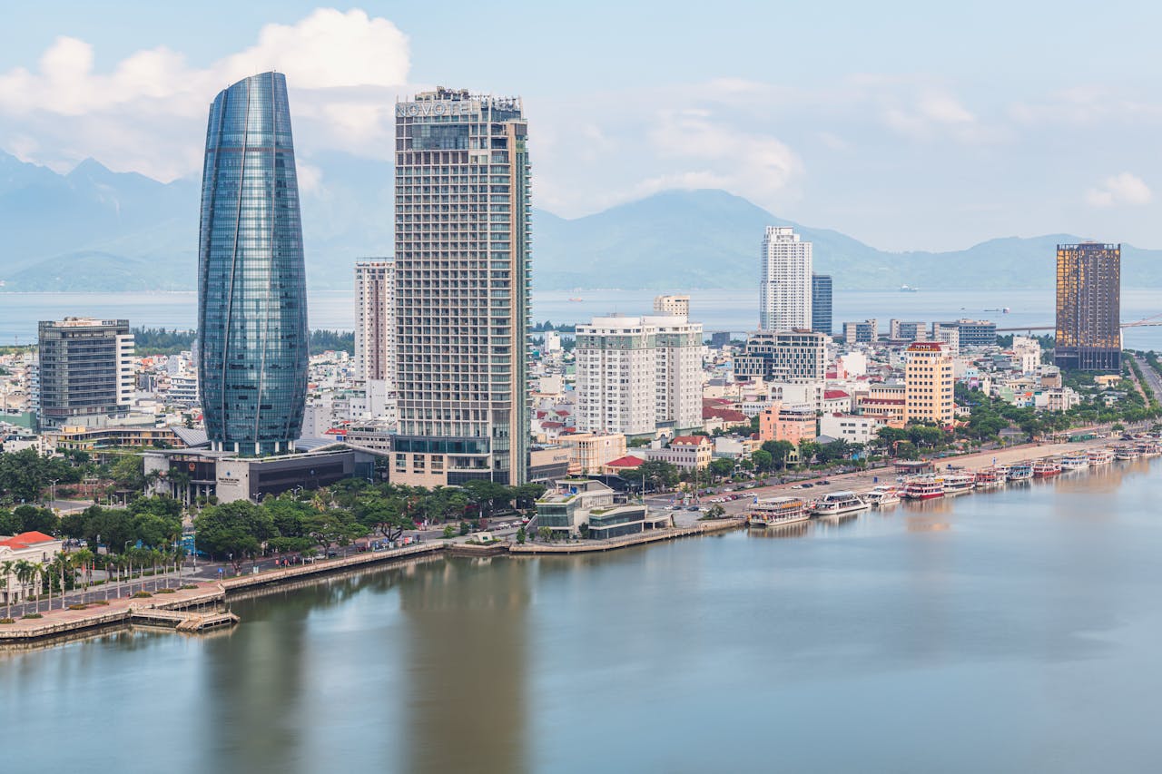 our-experience Stunning aerial view of Da Nang skyline with skyscrapers by the river. Perfect for travel and urban stock photos.
