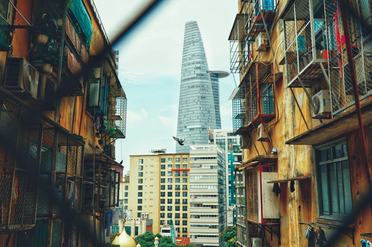 about-img Vibrant urban landscape featuring Bitexco Tower surrounded by diverse architecture in Ho Chi Minh City.